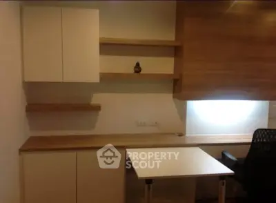 Modern study room with sleek wooden shelves and desk, perfect for productivity.
