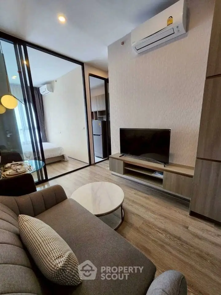 Modern living room with sleek furniture and air conditioning in a stylish apartment.