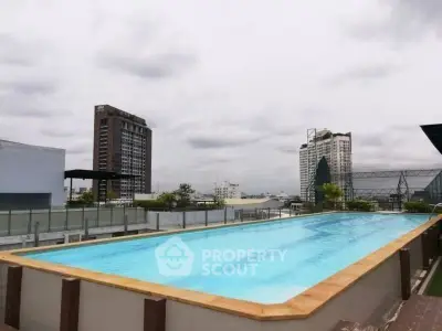 Stunning rooftop pool with city skyline views, perfect for relaxation and leisure.