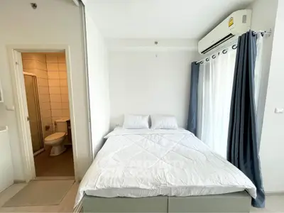 Cozy bedroom with ensuite bathroom and natural light from large window
