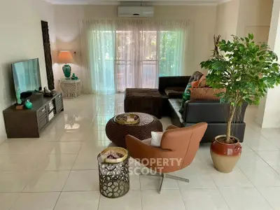 Spacious living room with modern decor and large windows offering natural light.