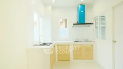 Bright modern kitchen with sleek cabinetry and ample natural light, perfect for culinary enthusiasts.