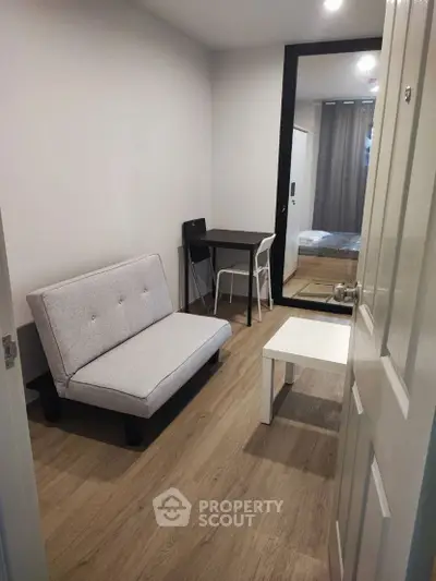 Cozy studio apartment with modern furnishings and wooden flooring, ideal for urban living.