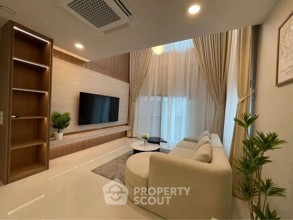 Luxurious living room with high ceilings, elegant curtains, and modern decor