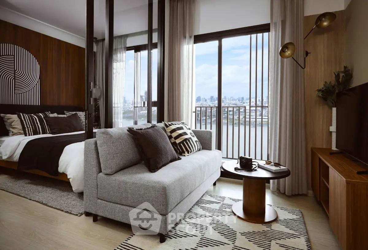 Modern living room with stylish decor and city view, featuring a cozy sofa and elegant furnishings.