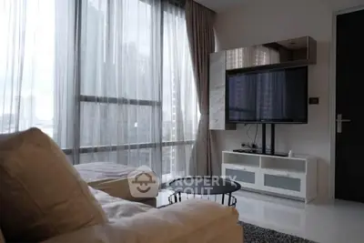 Modern living room with large windows and sleek furniture in a high-rise apartment.
