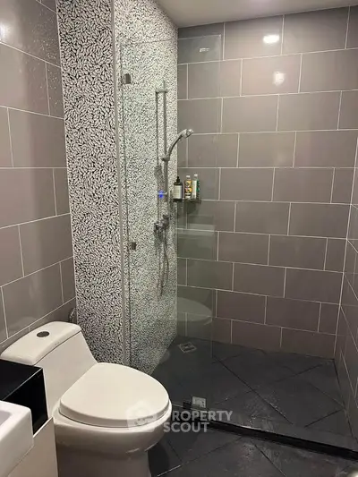Modern bathroom with sleek tile design and glass shower enclosure