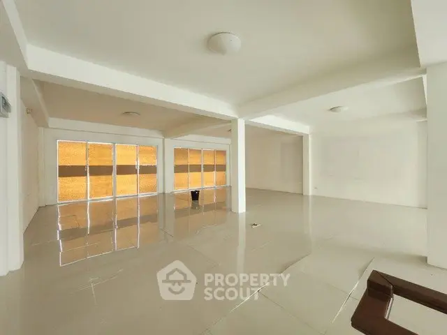 Spacious open-plan interior with glossy tiled floors and large windows, ideal for customization.