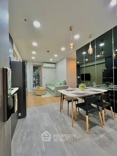 Modern open layout living and dining area with stylish decor and ample natural light.