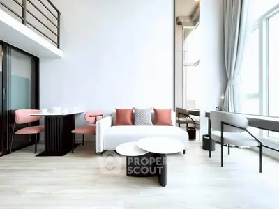 Modern living room with high ceilings and stylish furniture in a bright apartment.