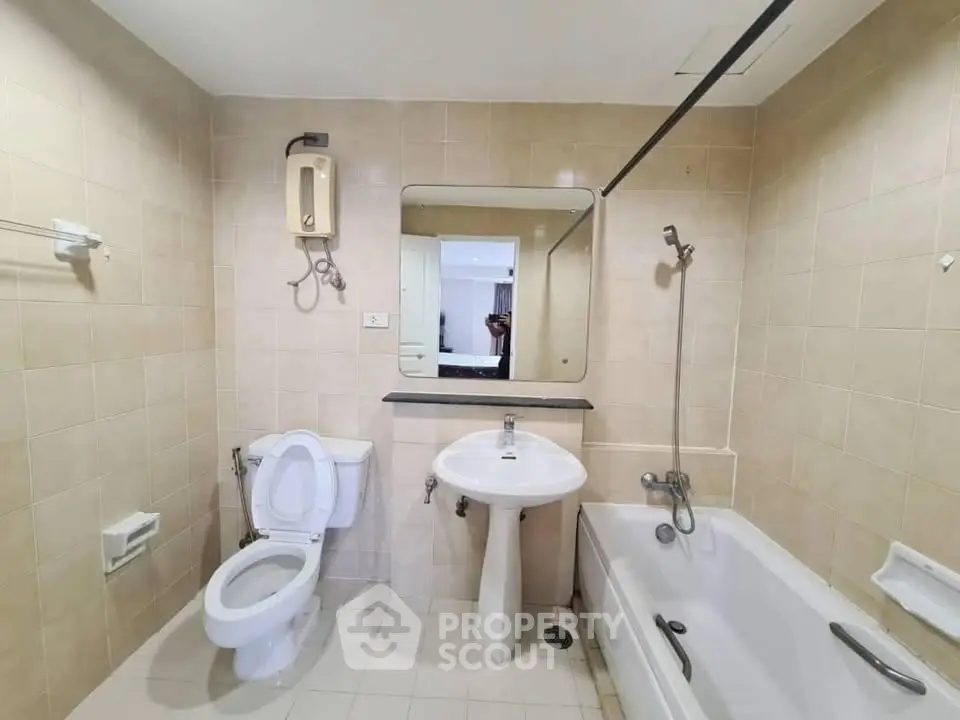 Spacious bathroom with bathtub and modern fixtures in a contemporary apartment.