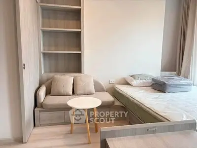 Modern bedroom with built-in shelving and cozy seating area