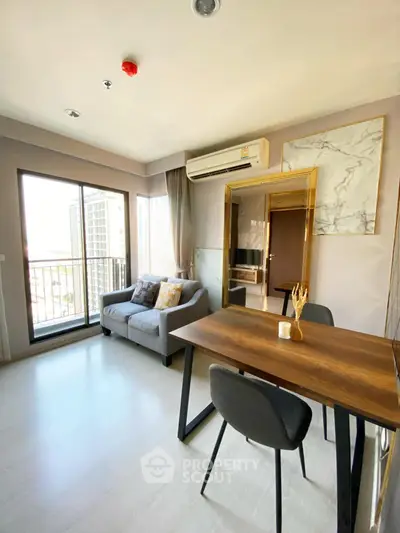 Modern living room with balcony view, featuring stylish furniture and natural light.