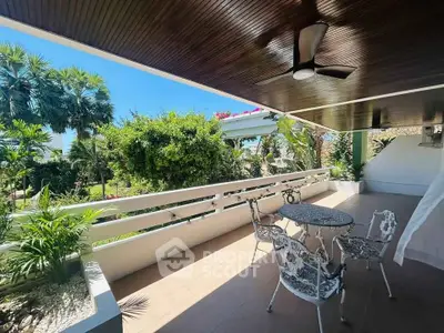 Spacious balcony with elegant seating and lush garden view