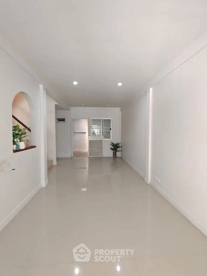 Spacious and bright living room with modern minimalist design and elegant flooring.