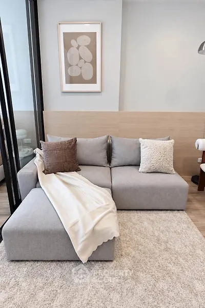 Modern living room with stylish gray sofa and cozy decor