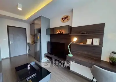 Modern living room with sleek furniture and integrated kitchen area.