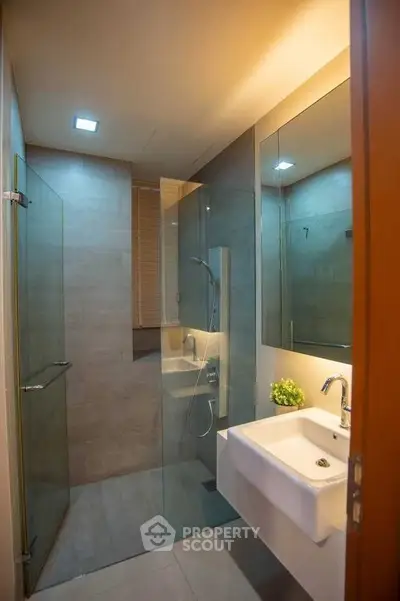 Modern bathroom with glass shower and sleek sink design