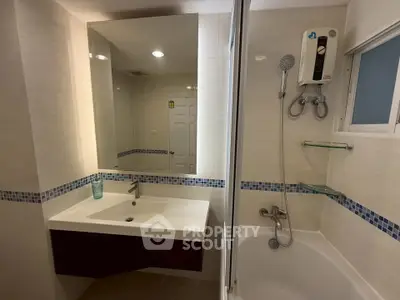 Modern bathroom with bathtub and sleek fixtures in a stylish apartment.