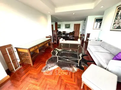Spacious living room with elegant wooden flooring and modern furniture