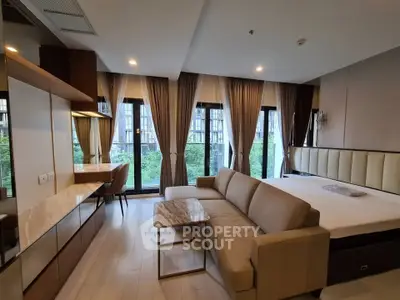Modern studio apartment with large windows and elegant furnishings