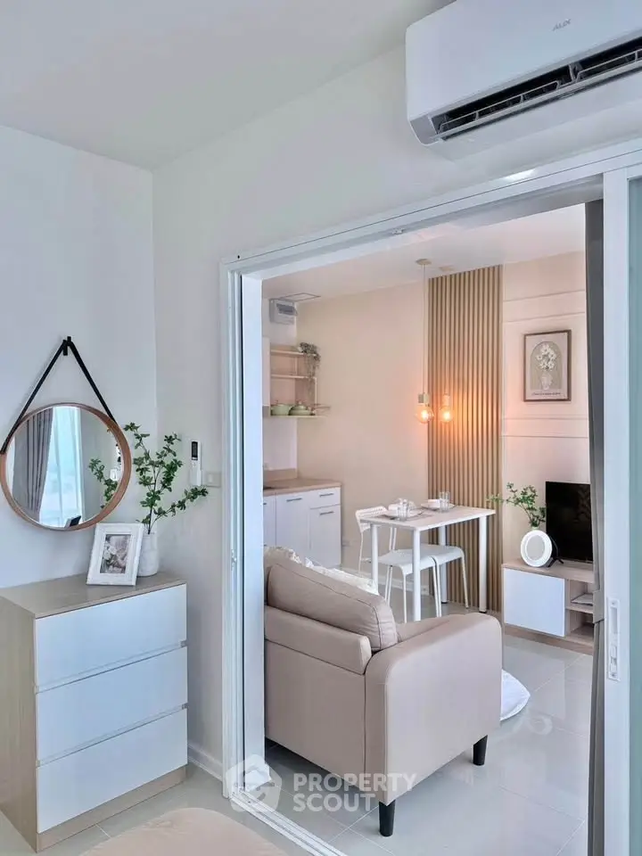 Modern open-plan living room with stylish decor and air conditioning in a cozy apartment.