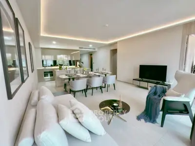 Spacious modern living room with open kitchen and elegant dining area.
