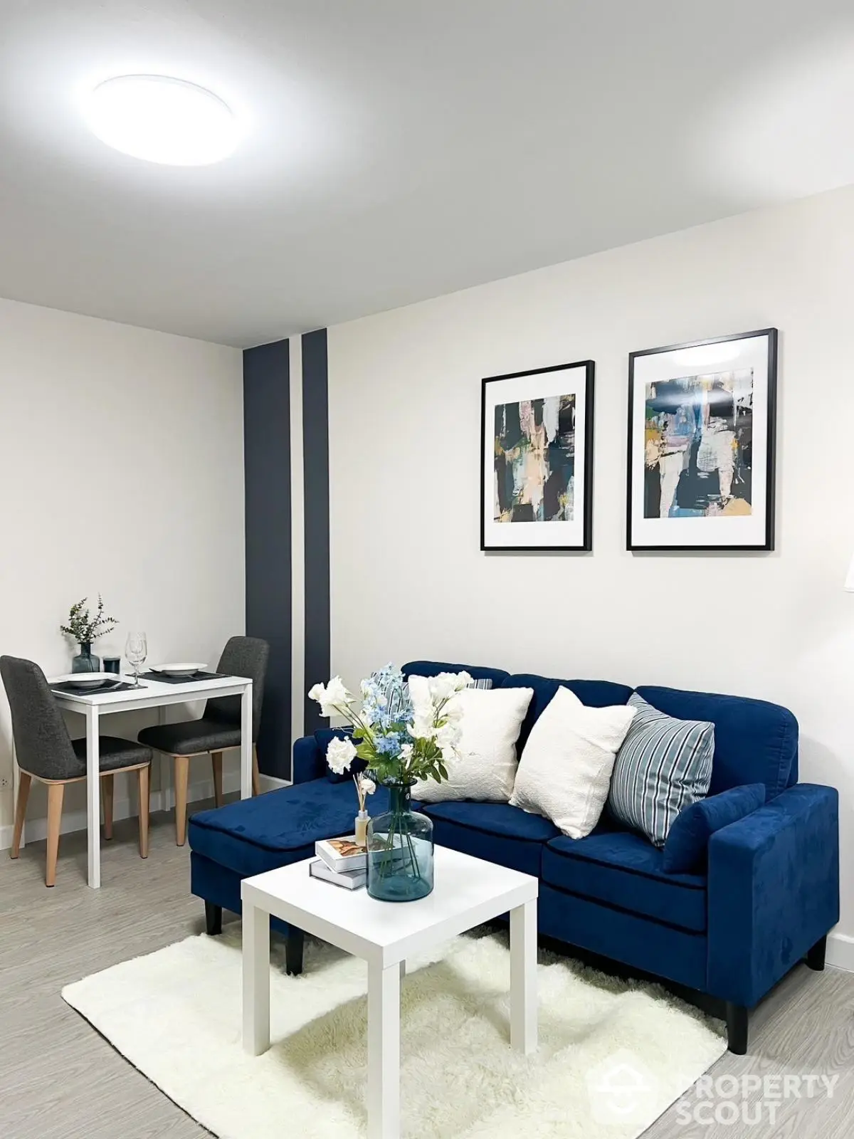 Modern living room with blue sofa and elegant decor, perfect for cozy gatherings.