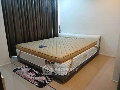 Spacious bedroom with large bed and wooden flooring, perfect for comfort and relaxation.