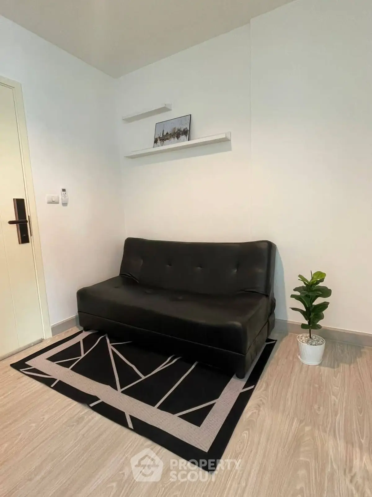 Modern living room with sleek black sofa and stylish decor