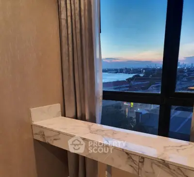 Stunning sunset view from a modern apartment window with elegant marble ledge.