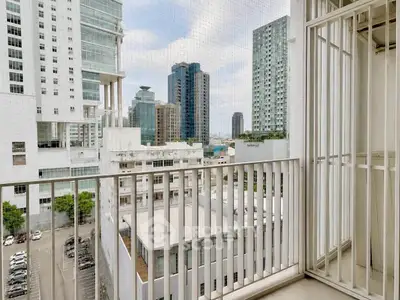 Modern urban balcony with city skyline view, perfect for relaxation and enjoying the vibrant city life.