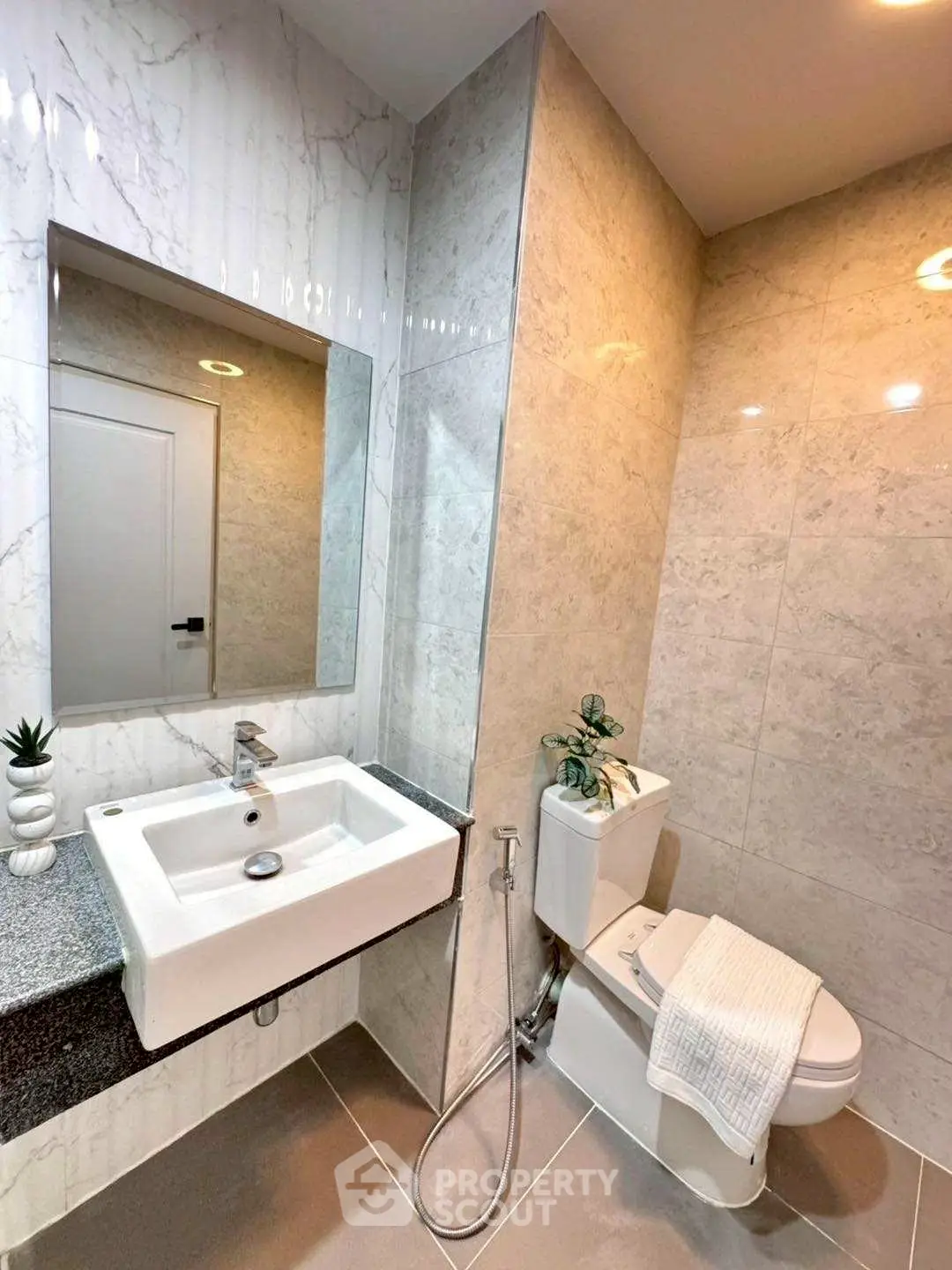 Modern bathroom with sleek marble tiles and contemporary fixtures.