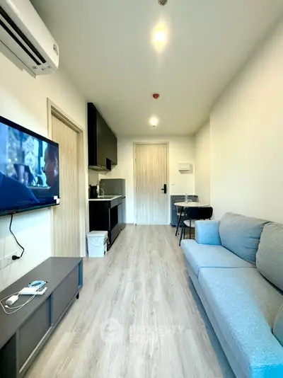 Modern living room with sleek furniture and open kitchen layout