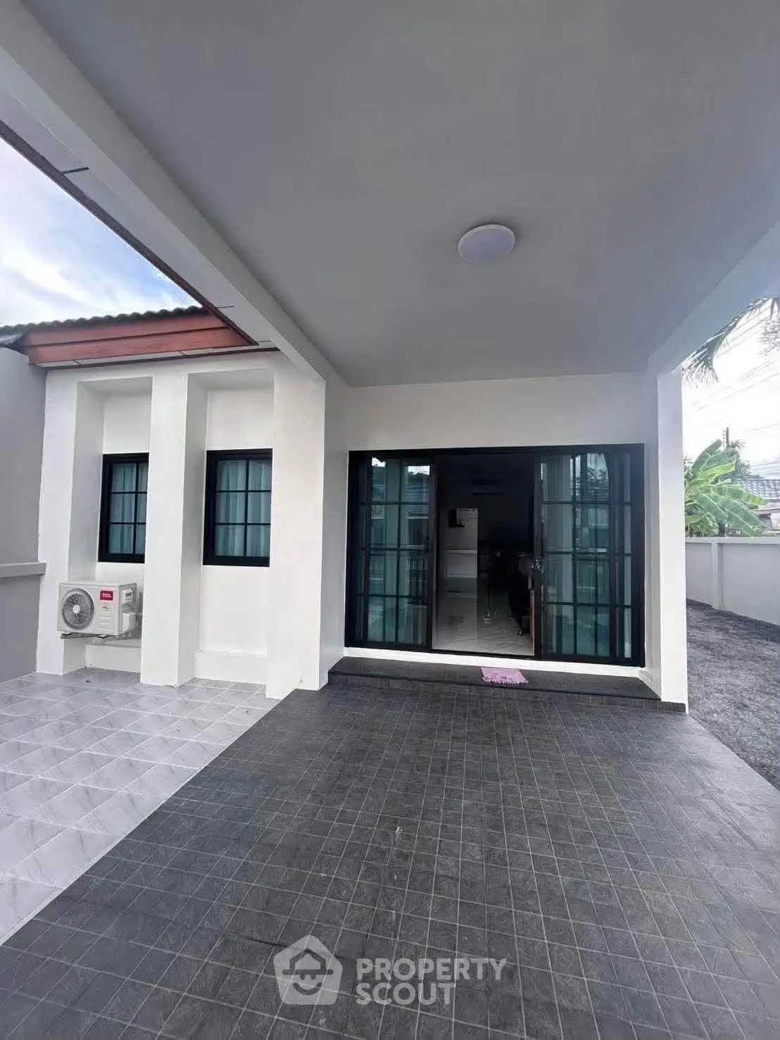 Modern exterior view of a stylish home with sleek windows and spacious driveway.