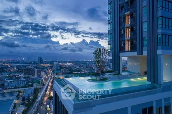 Luxurious high-rise building with stunning rooftop pool and panoramic city view at dusk.
