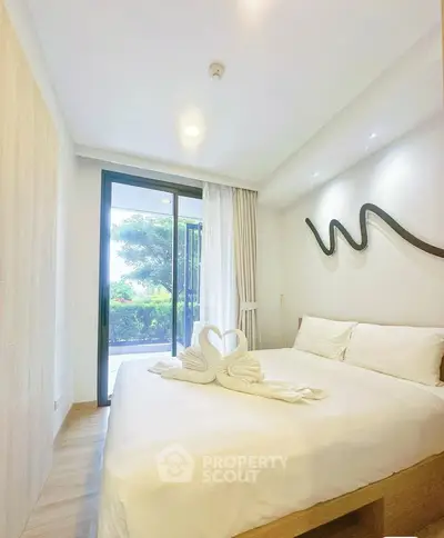Modern bedroom with elegant decor and garden view, featuring stylish lighting and cozy ambiance.