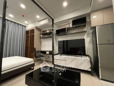 Modern studio apartment with sleek furniture and integrated storage solutions.
