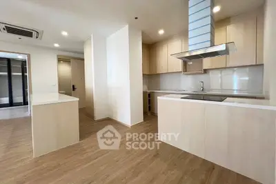Spacious modern kitchen with open layout and sleek wooden flooring
