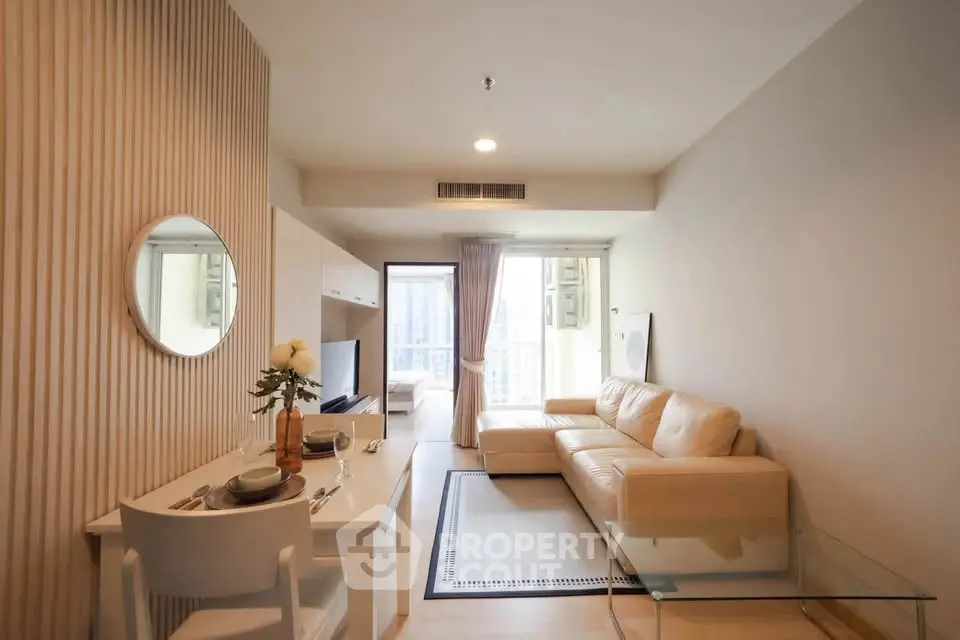 Modern living room with beige sofa and dining area in a stylish apartment