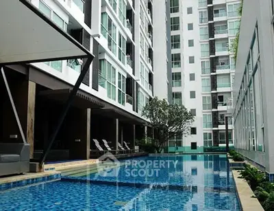 Luxurious condominium with a stunning poolside view, perfect for relaxation and modern living.