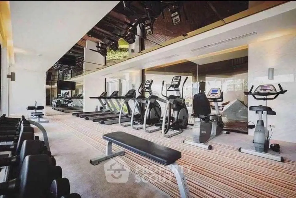 Modern gym with state-of-the-art equipment in luxury residential building.