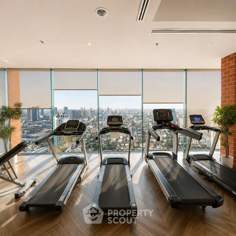 Modern gym with treadmills and panoramic city view in luxury high-rise building.