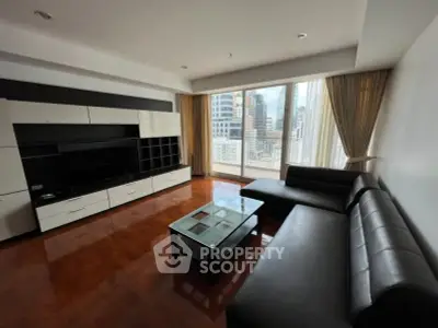 Spacious modern living room with city view, sleek furniture, and large windows.