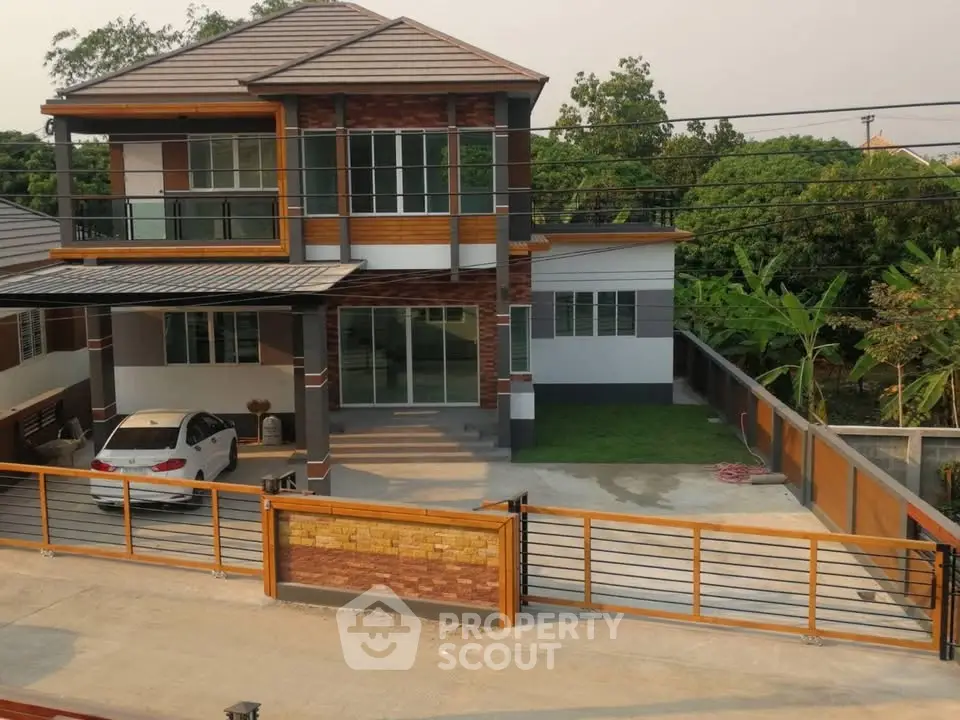 Modern two-story house with spacious driveway and lush greenery