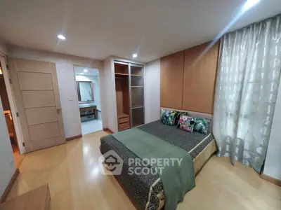 Spacious bedroom with modern decor and ample closet space