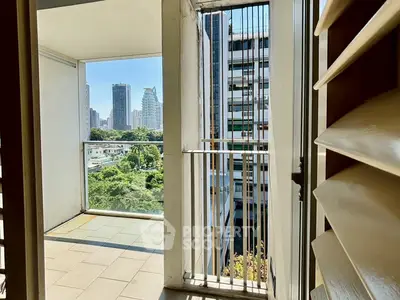 Spacious balcony with stunning city view and lush greenery, perfect for urban living.