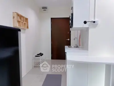 Compact kitchen area with modern appliances and sleek design, perfect for urban living.