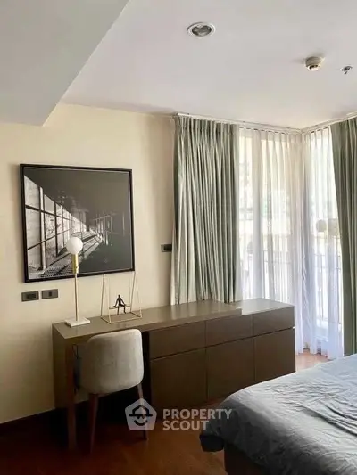 Modern bedroom with stylish desk and large window offering natural light