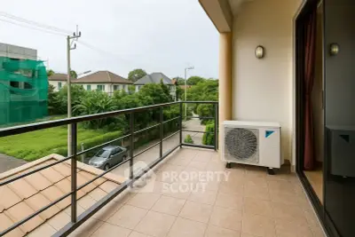 Spacious balcony with scenic view and air conditioning unit in modern residential area.